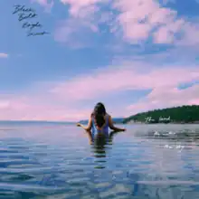 Katherine Paul standing in waist-high water with her back turned to the viewer