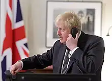 Colour photograph of Boris Johnson speaking on the phone with Ursula von der Leyen