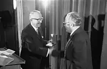 Walter Hallstein on stage, shaking hands while receiving prize