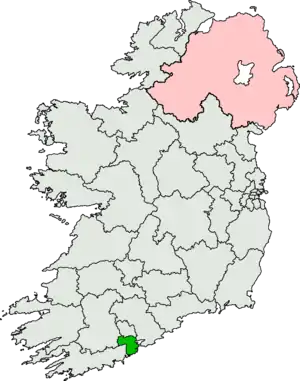 A schematic map of Ireland with only constituency borders and state borders drawn, a small segment is highlighted in green, showing the location of the constituency