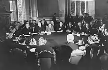 Men in suits sitting around a circular table