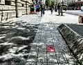 Red stone marking the place of the assassination of President Sadi Carnot on the Rue de la République in 1894
