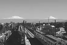 A picture of Line 12's overground track with a train passing by.
