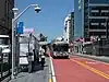 A bus stop with bus in the median of an urban arterial