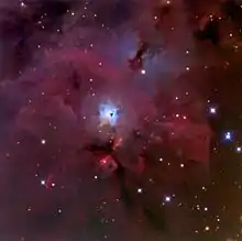 The reflection nebula NGC 1999 (blue cloud in the center) and the Herbig-Haro Objects HH 1/2 below NGC 1999 as small pink clouds.