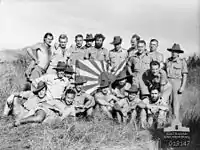 Image 19New Guinea Volunteer Rifles with captured Japanese flag, 1942 (from History of Papua New Guinea)