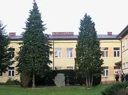 School in Szebnie with the camp memorial stone