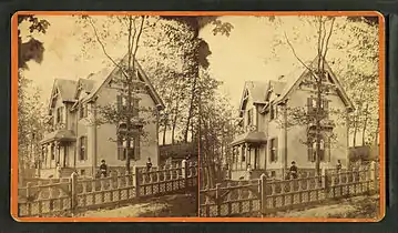People in front of a large wood-frame house, 19th-20th century