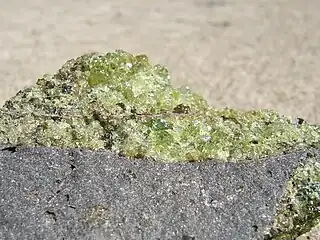 Peridot olivine with minor pyroxene, on vesicular basalt. (field of view = 35 mm)
