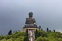 Tian Tan Buddha, a large bronze statue of Amoghasiddhi, located at Ngong Ping, Lantau Island, in Hong Kong. The statue is 34 metres (112&nbsp;ft) tall, weighs over 250 metric tons (280 short tons)