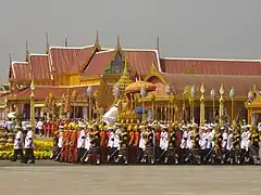 An officer supporting the urn of Princess Bejaratana Rajasuda on the Lord's Palanquin wears the Nobleman's Gown and the Lomphok, 10 April 2012.