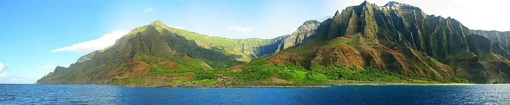 view of the Nā Pali coastline from the ocean. It is part of the Nā Pali Coast State Park which encompasses 6,175 acres (20 km2) of land and is located on the northwest side of Kauaʻii.
