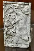 Standing man holding branches of lotus flowers.