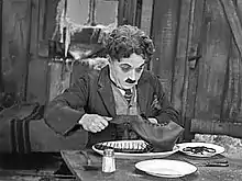 Charlie Chaplin eating a boot in his film The Gold Rush