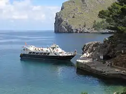Tourists board a boat in Majorca (Spain) for a coastal trip from Sa Calobra to Port de Soller