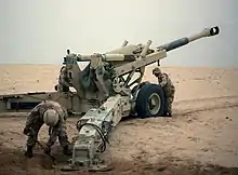 A M198 Howitzer with a split trail carriage which is capable of wide angles of traverse and elevation.  The two cylinders on either side of the barrel are equilibriators.