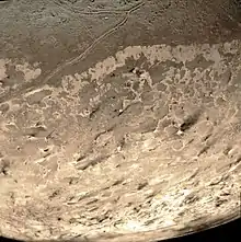Dark streaks across Triton's south polar cap surface, thought to be dust deposits left by eruptions of nitrogen geysers