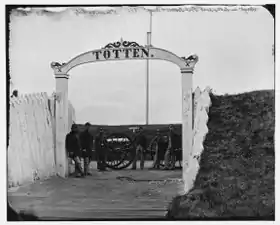 Men and gun of 3d Massachusetts Heavy Artillery at the Fort Totten ornamental gate in 1865
