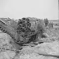 A Churchill tank, carrying a fascine, crosses a ditch using an already deployed fascine, 1943.