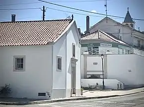 Capela do Senhor Bom Jesus dos Aflitos em primeiro plano; torre sineira da Igreja de Nossa Senhora de Fátima ao fundo