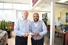 Group 1 CEO Earl Hesterberg (Left) delivers check to support employee affected by Hurricane Harvey