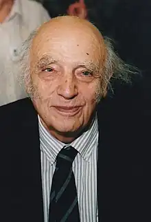 Fotografia de Jean Chesneaux em que ele aparece de terno e gravata com um quase sorriso.