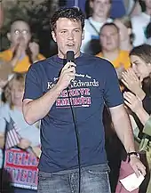 Ben Affleck speaking into a microphone while wearing a Kerry/Edwards campainha tshirt