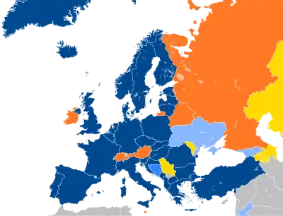 A map of Europe with countries in blue, cyan, orange, and yellow based on their NATO affiliation