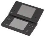 An opened clamshell dual-screen handheld device. A camera is embedded in the internal hinge.