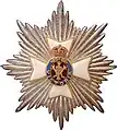 A Cifra real e imperial da Rainha Vitória faz parte do emblema da Ordem Real Vitoriana cercada por uma estrela de Brunswick