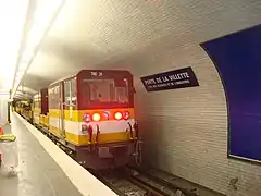 Um trem de manutenção das vias passa na estação pela tarde.