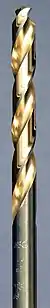 A steel colored twist drill bit with the spiral groove colored in a golden shade.