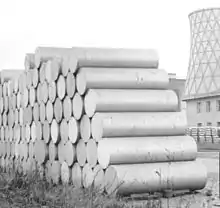 Extrusion billets of aluminium piled up before a factory