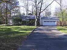 Treys childhood home in Princeton, New Jersey. A ranch style house and driveway.