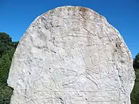 Homem morto sendo recebido por uma valquíria no alémDesenho feito na pedra