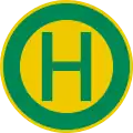 rundes Schild mit grünem Rand und einem grünen Buchstaben H auf gelbem Grund