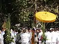 a senior monk, Kiaw, was provided with a glòt umbrella as he walked through a group of government officials, 2008.